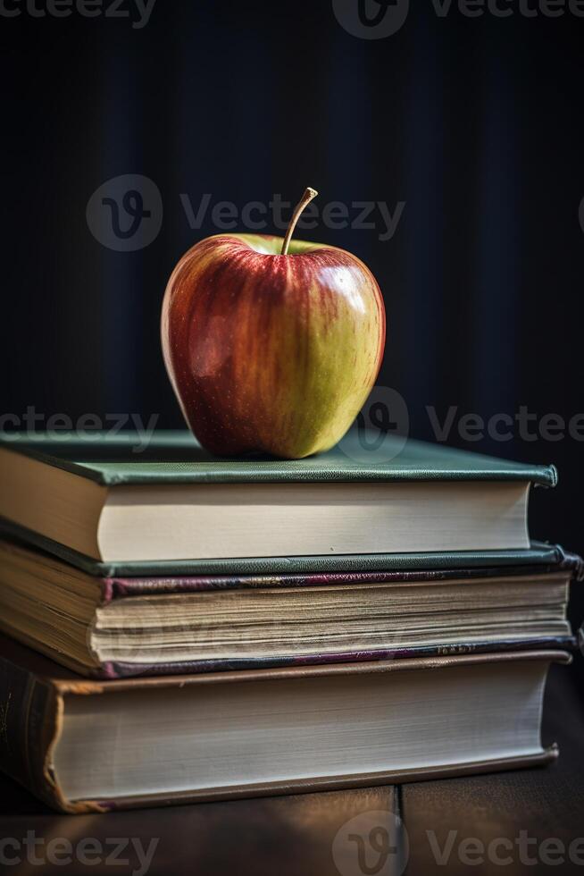 a stack of books with an apple on top of them photo
