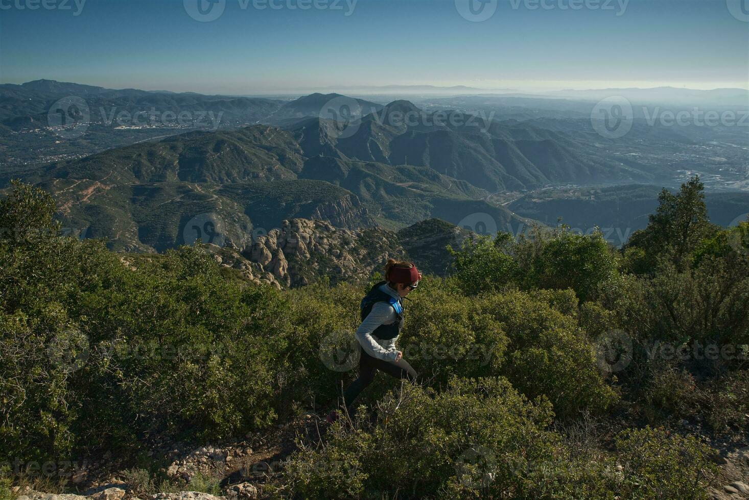 Woman runs through the mountains of Montserrat in Catalonia, Spain. photo