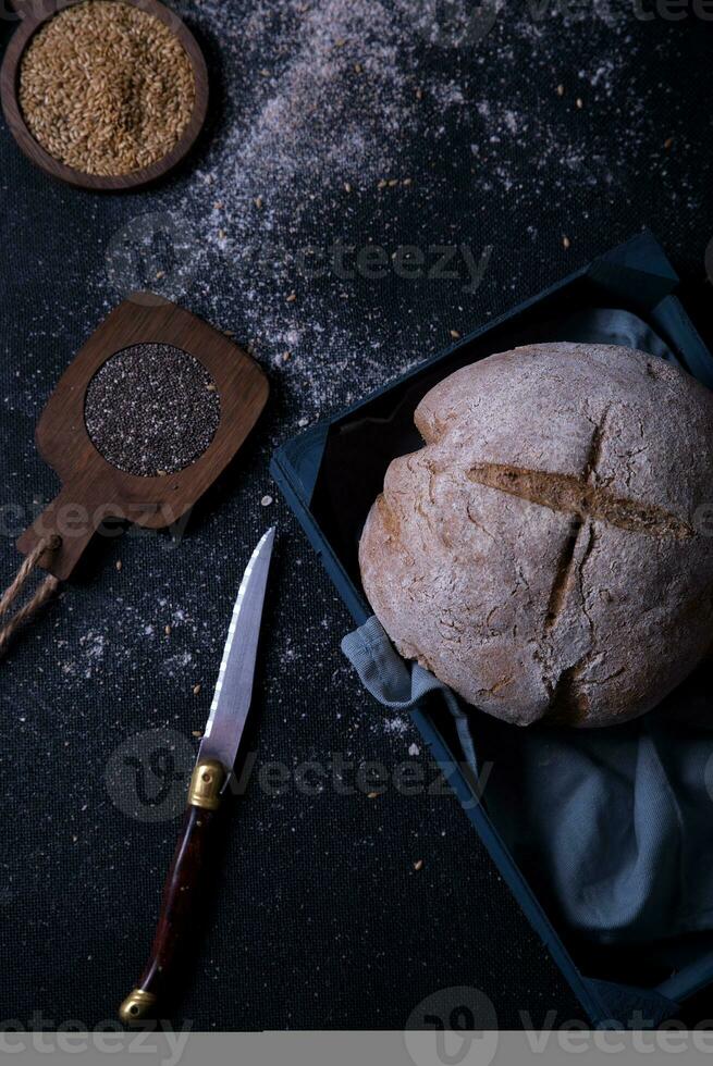Freshly prepared and cut bread served at the table with seeds. photo