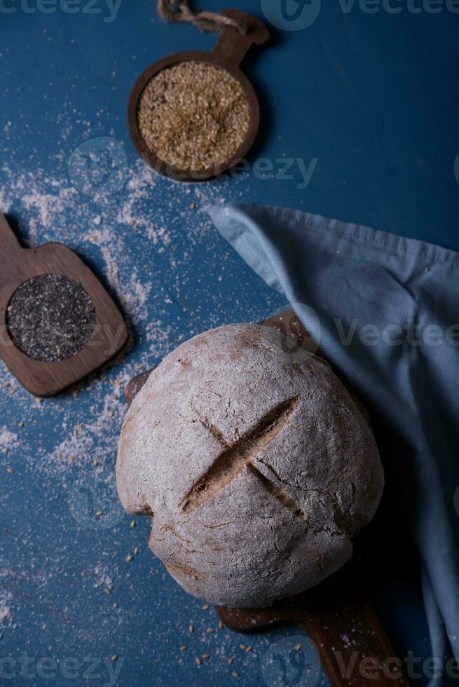 Freshly prepared and cut bread served at the table with seeds. photo