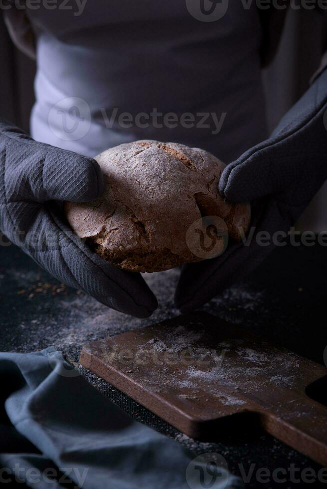 Hands leaving the prepared bread on the table. photo