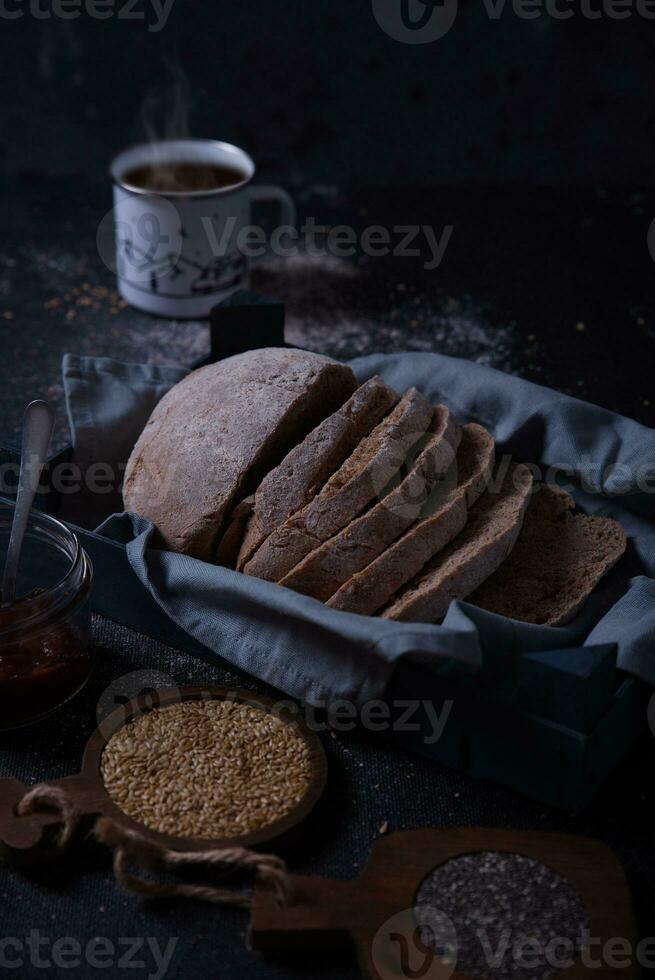 Freshly prepared and cut bread served at the table with seeds. photo