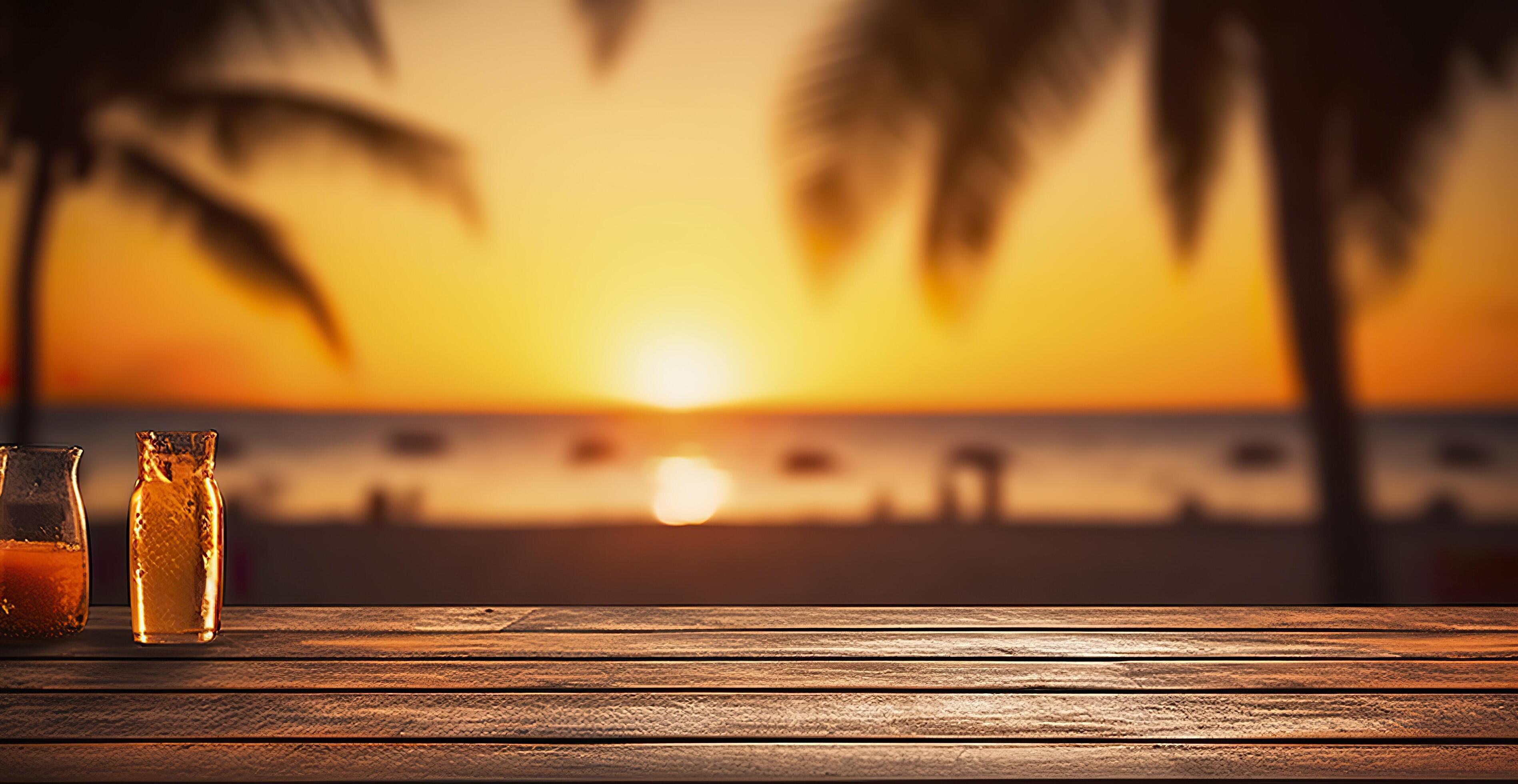 Empty wooden table in front of blurred tropical beach on sunset evening