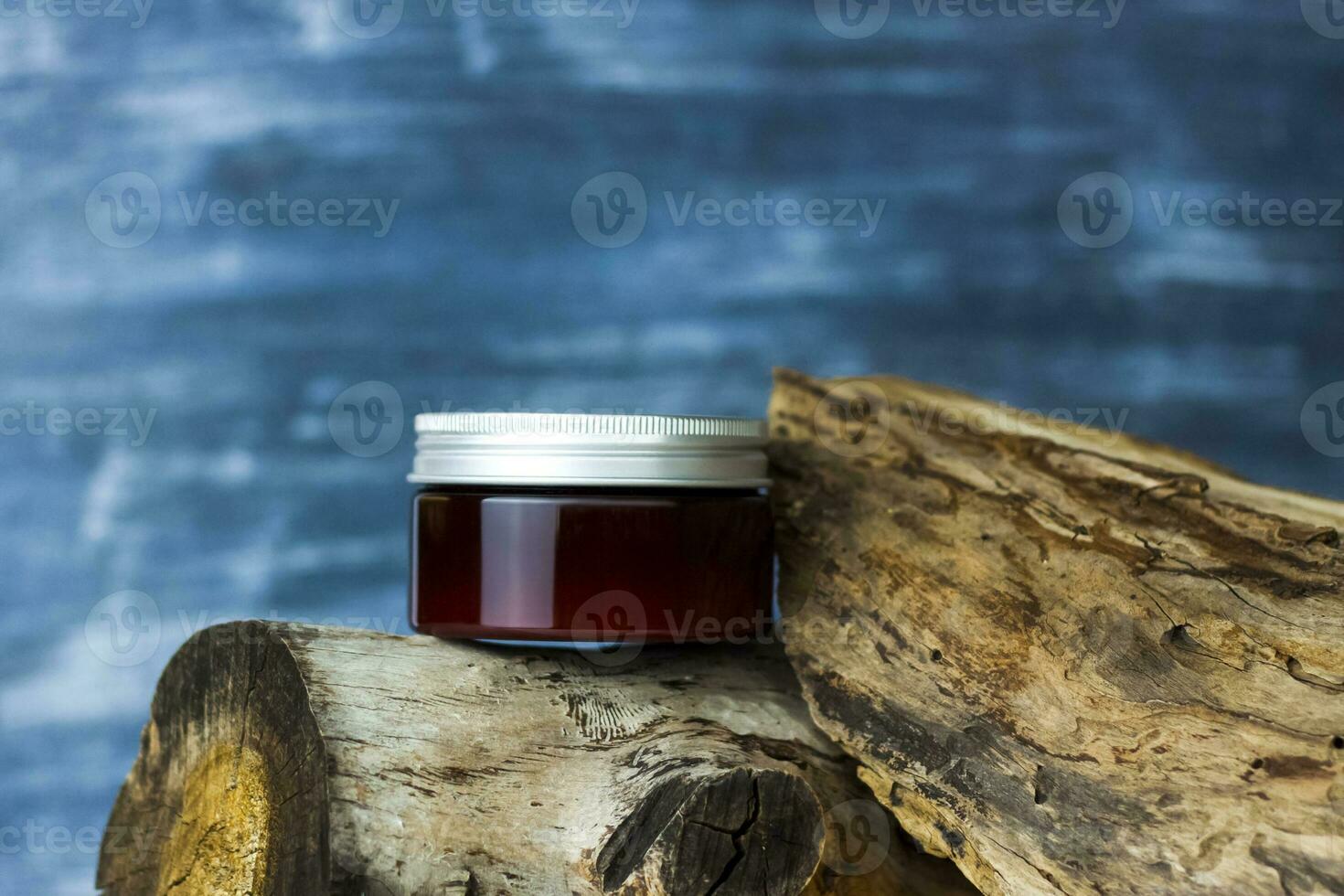 A jar of cream on the background of a dry stump and tree bark. Stylish appearance, layout, personality. Banner, a place for the text. photo