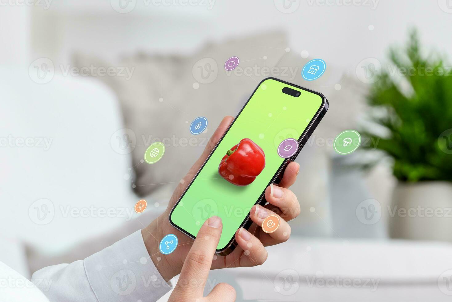 Using a smartphone to search for healthy food online. concept. Phone in woman hand with pepper on screen, online shopping and food icons flying arround phone photo