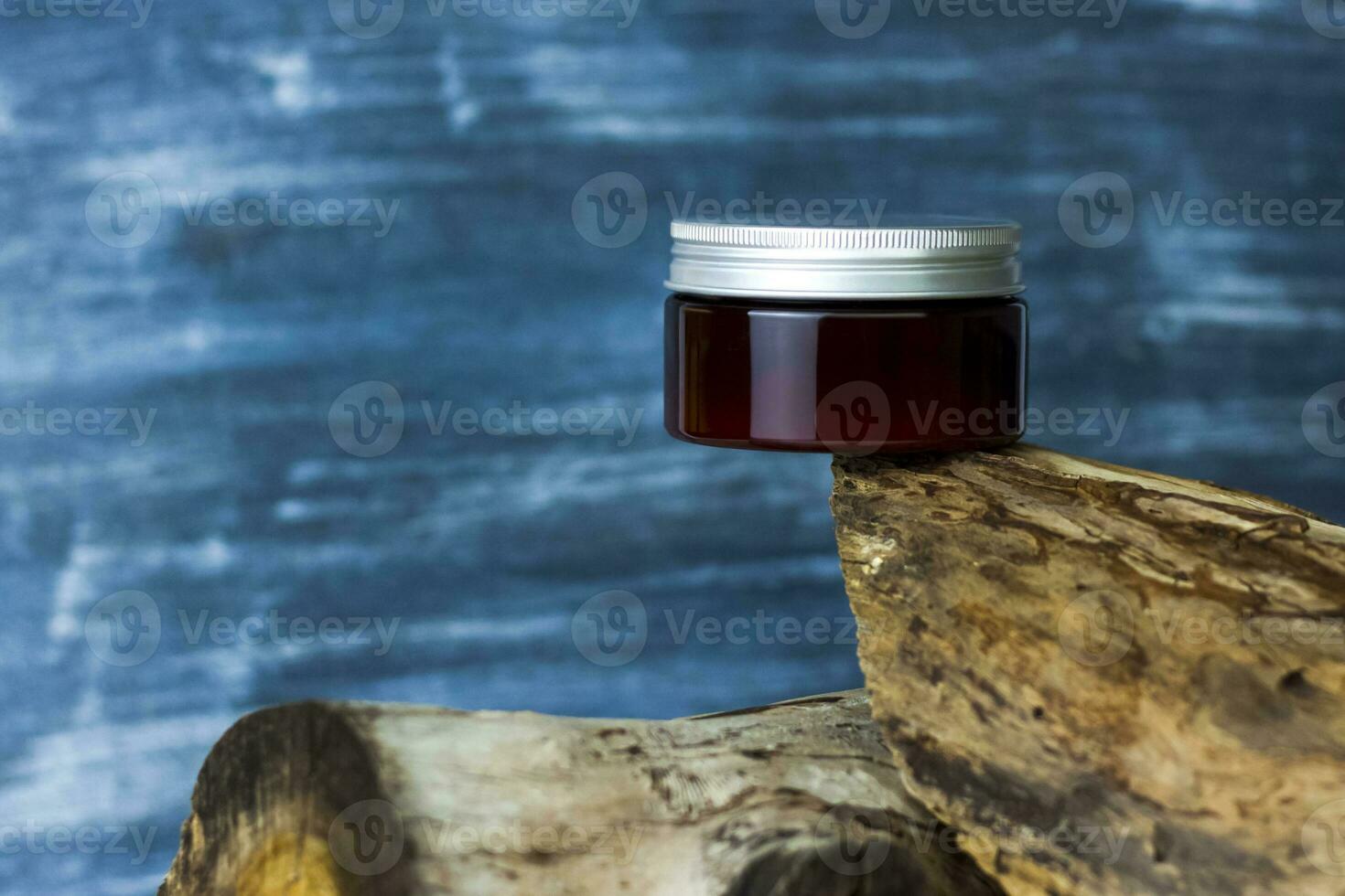 A jar of cream on the background of a dry stump and tree bark. Stylish appearance, layout, personality. Banner, a place for the text. photo