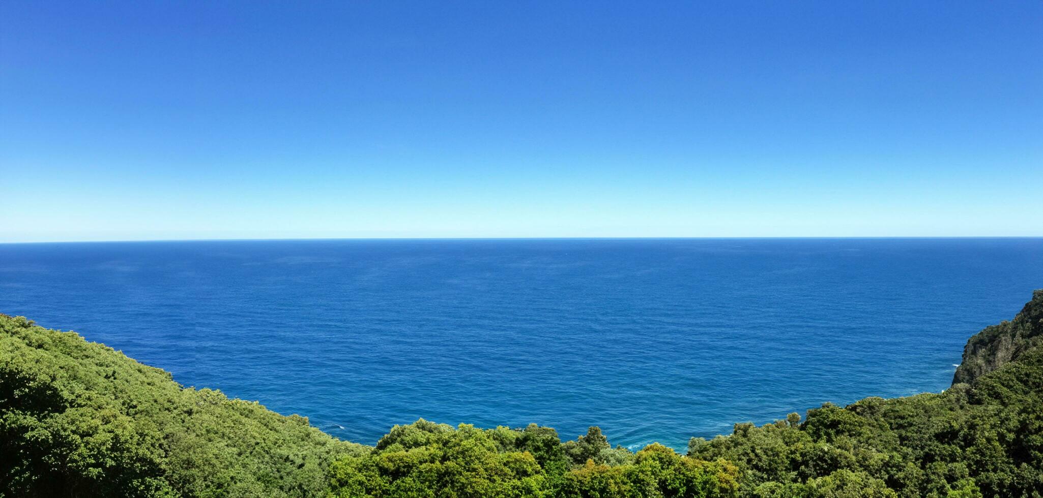High angle view of coastline and hills calm sea photo