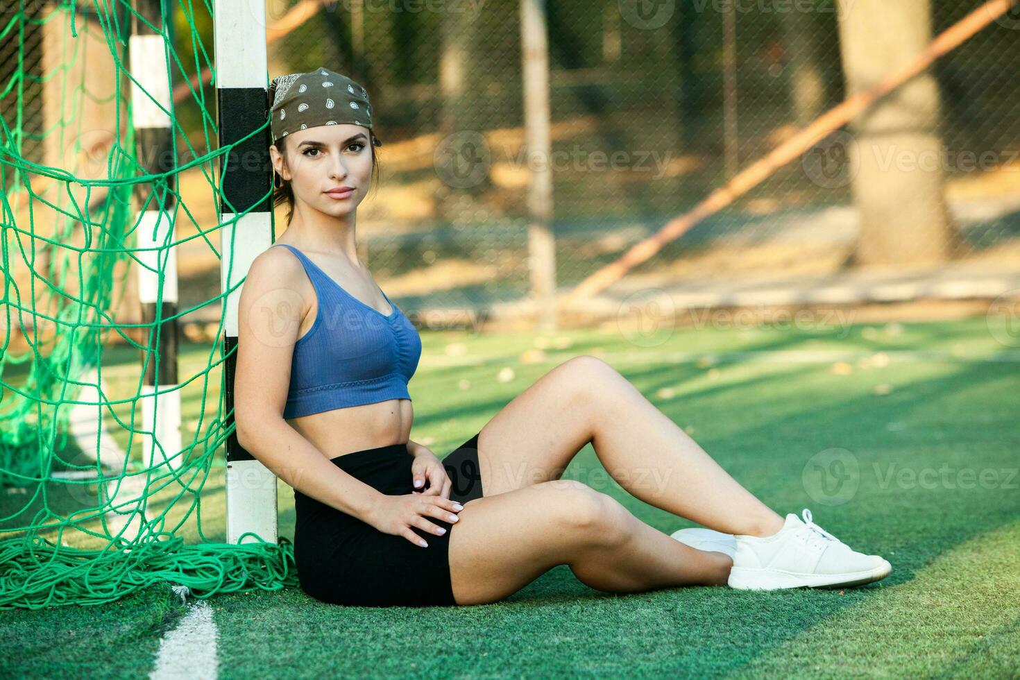 Athletic young woman in sportswear jogging in the park. Fitness and healthy lifestyle. Portrait of a beautiful young woman in sportswear outdoors. Sport fitness model  in park. photo