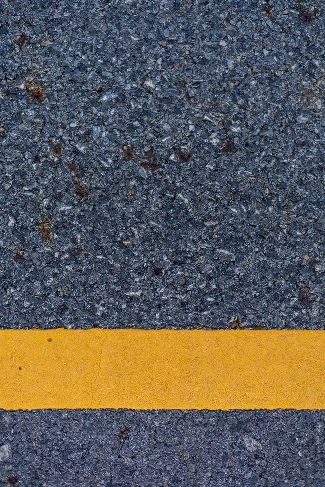 The paved road intersects with the yellow road line. photo