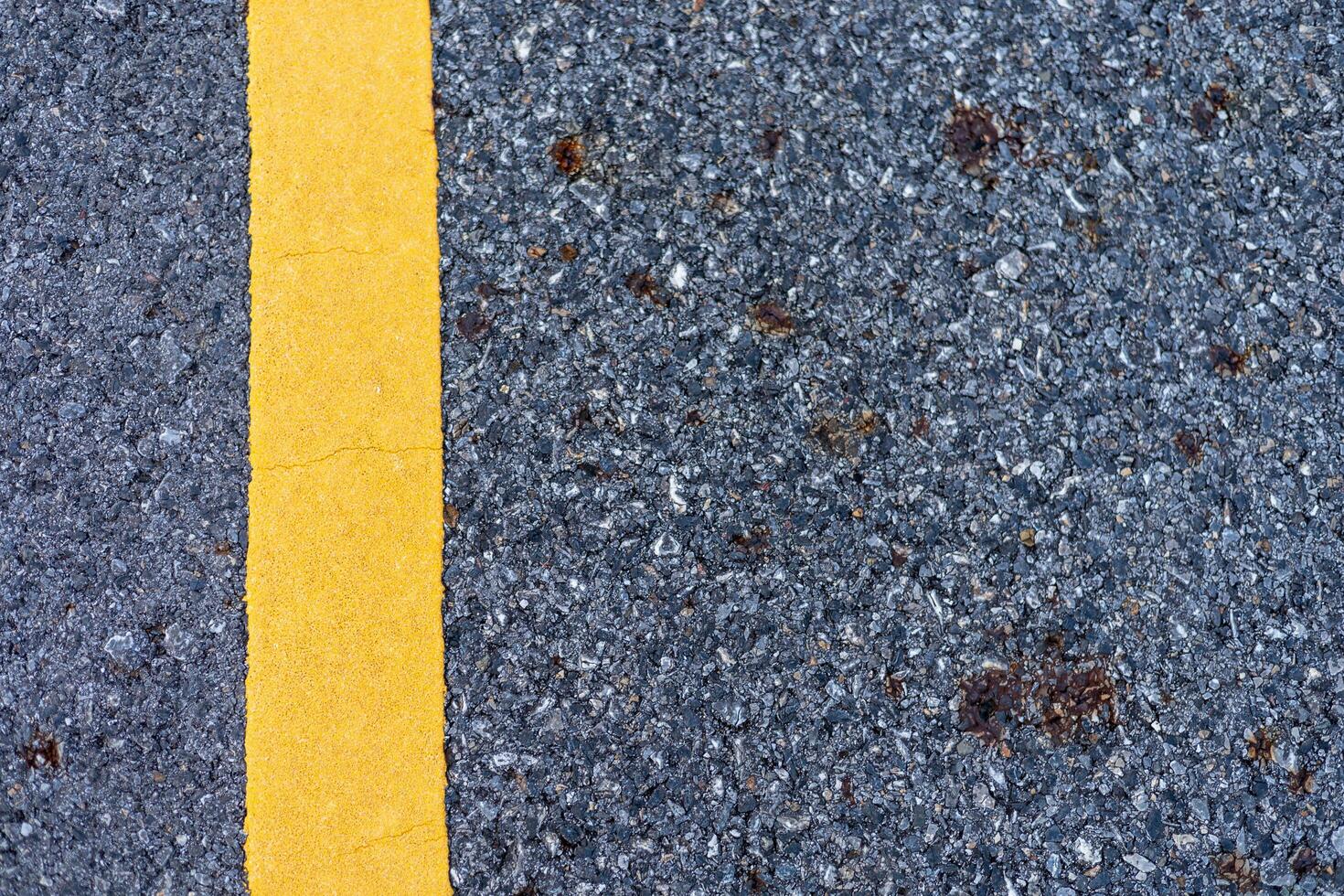 The paved road intersects with the yellow road line. photo