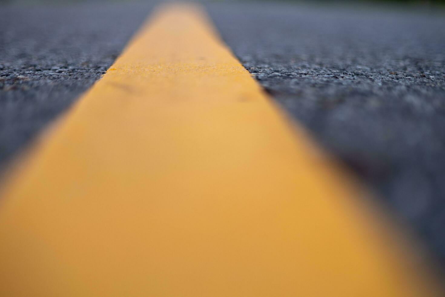 paved road with yellow road lines photo