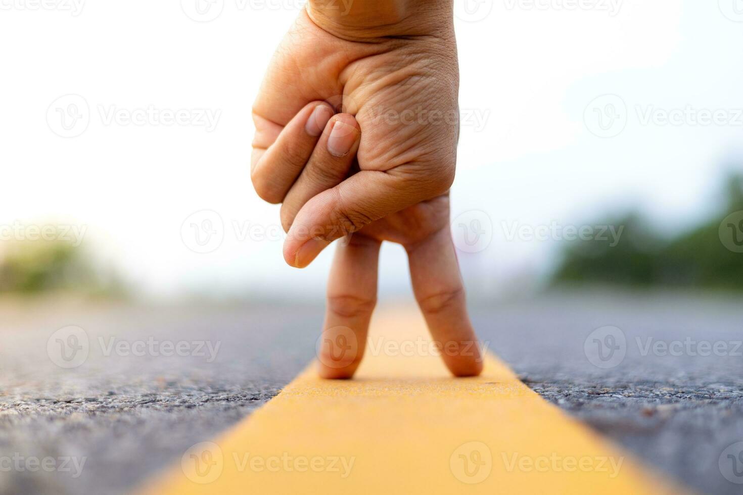 Man holding up two fingers on the street, soft sunlight in the evening telling him to fight. photo