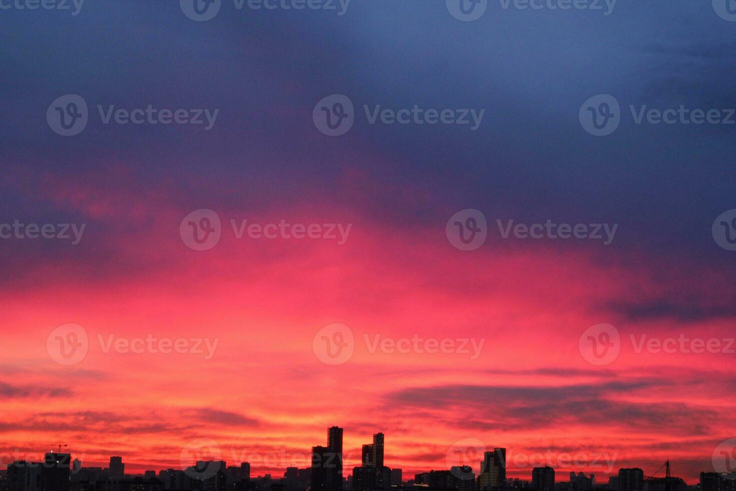 Colorful cloudy twilight beautiful sky cityscape sunset and morning sunrise. Dramatic evening night early morning view with city buildings silhouette. Panoramic background concept. Copy space for text photo