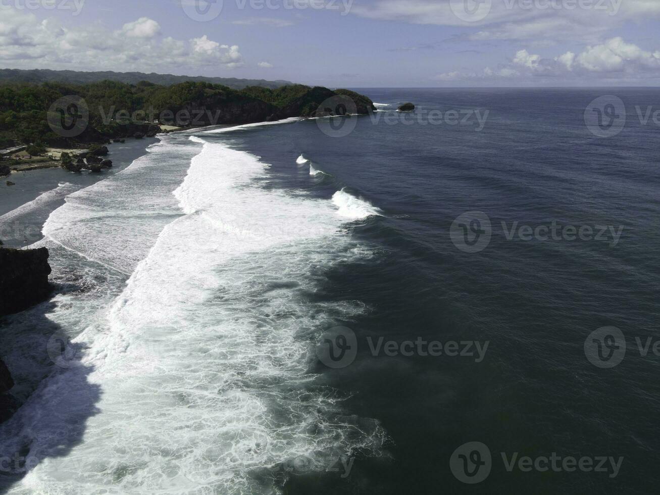 Aerial drone view of waves at the beach in Yogyakarta Indonesia photo