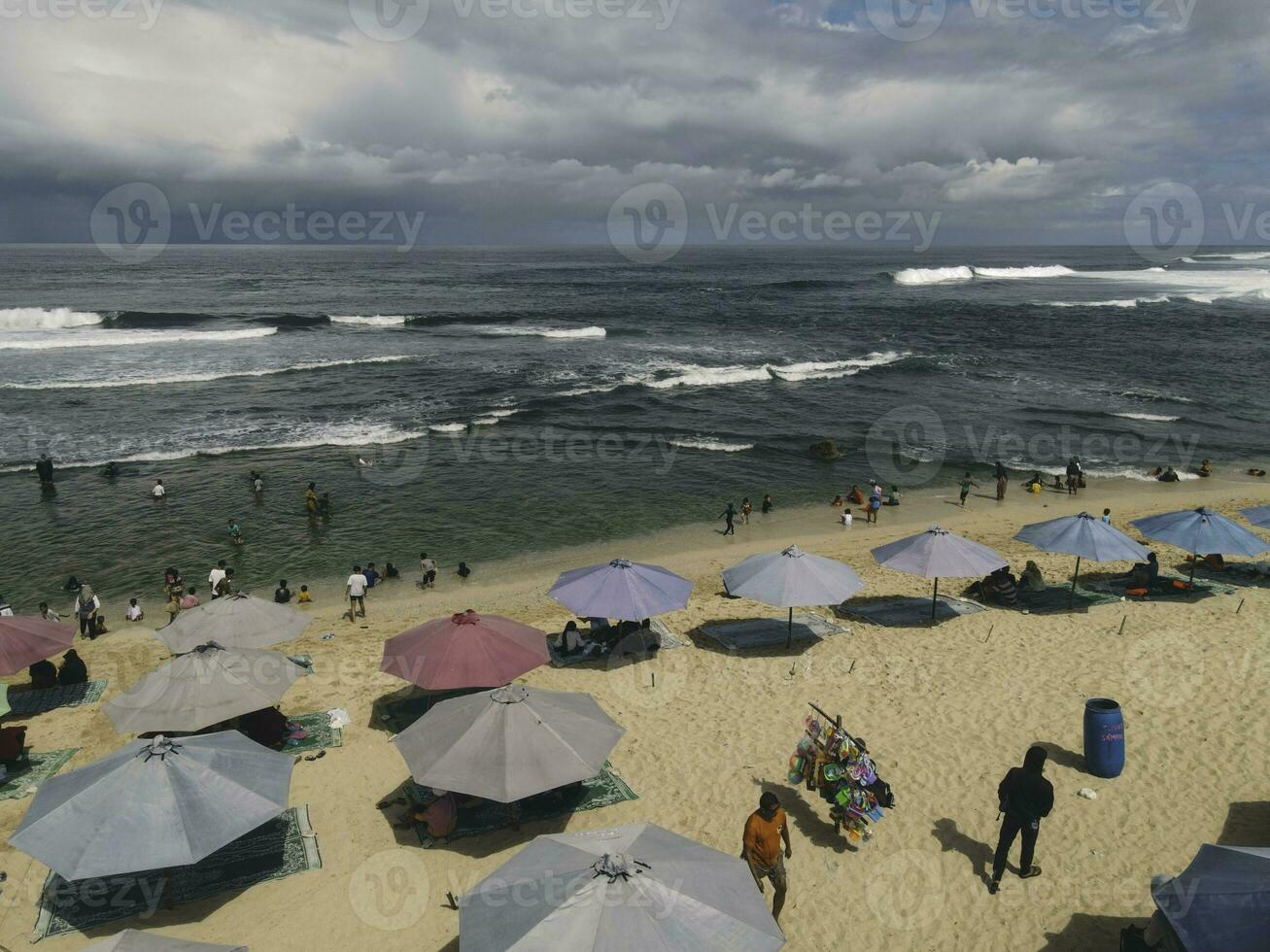 Aerial drone view of umbrellas at the beach in Yogyakarta Indonesia photo