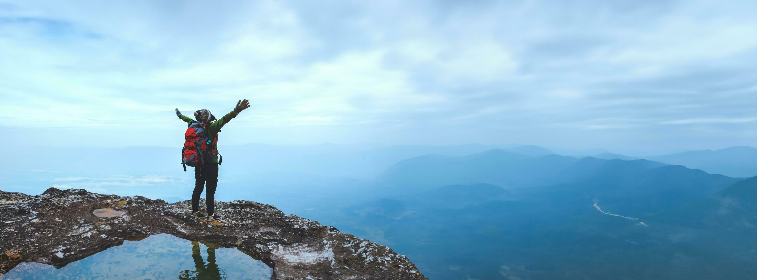 Asian women Travel photograph Nature. Travel relax ride a bike Wilderness in the wild. Standing on a rocky cliff. Thailand photo