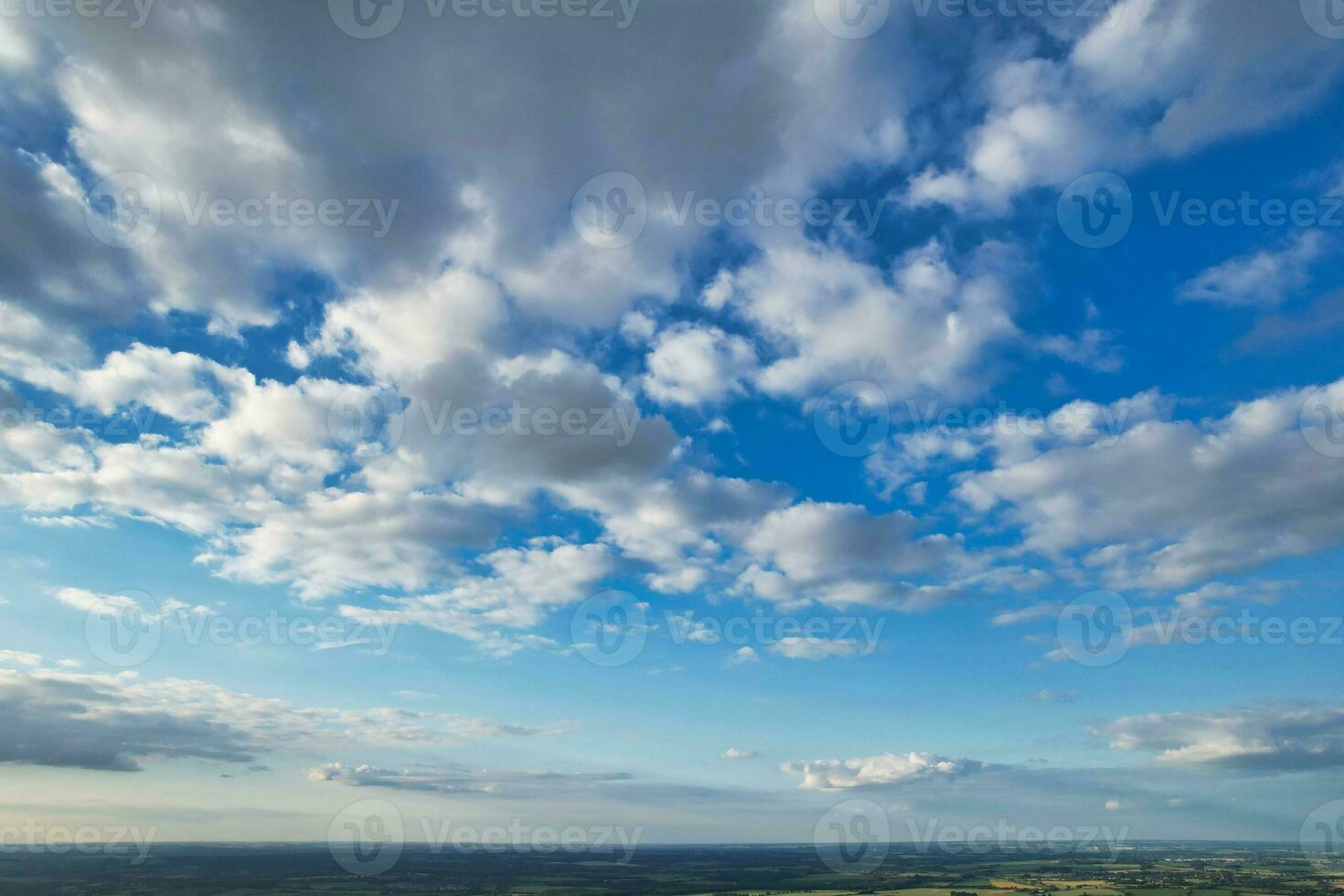 Most Beautiful High Angle view of Dramatical Sky and Clouds over British Countryside Landscape During Sunset photo