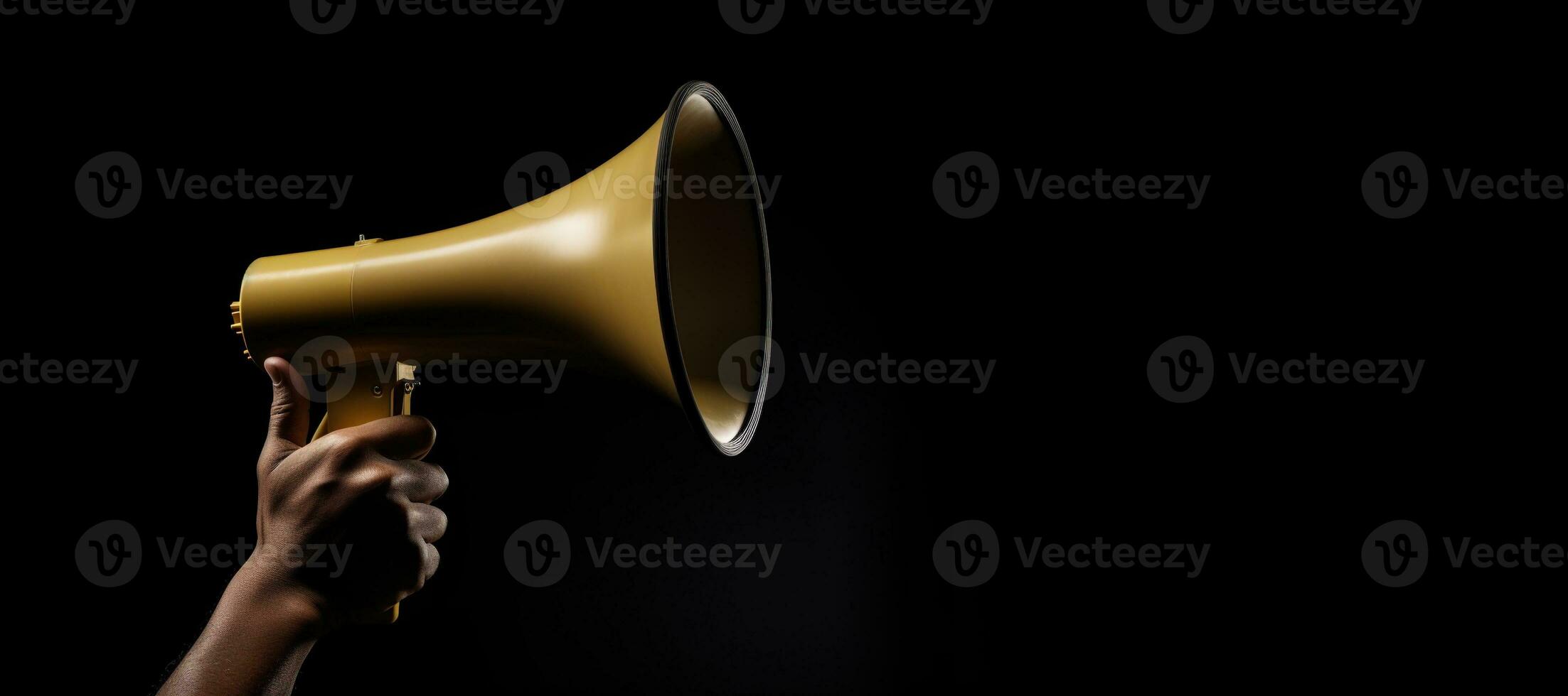 Generative AI, golden megaphone in hand on a empty black background, panoramic image with copy space photo