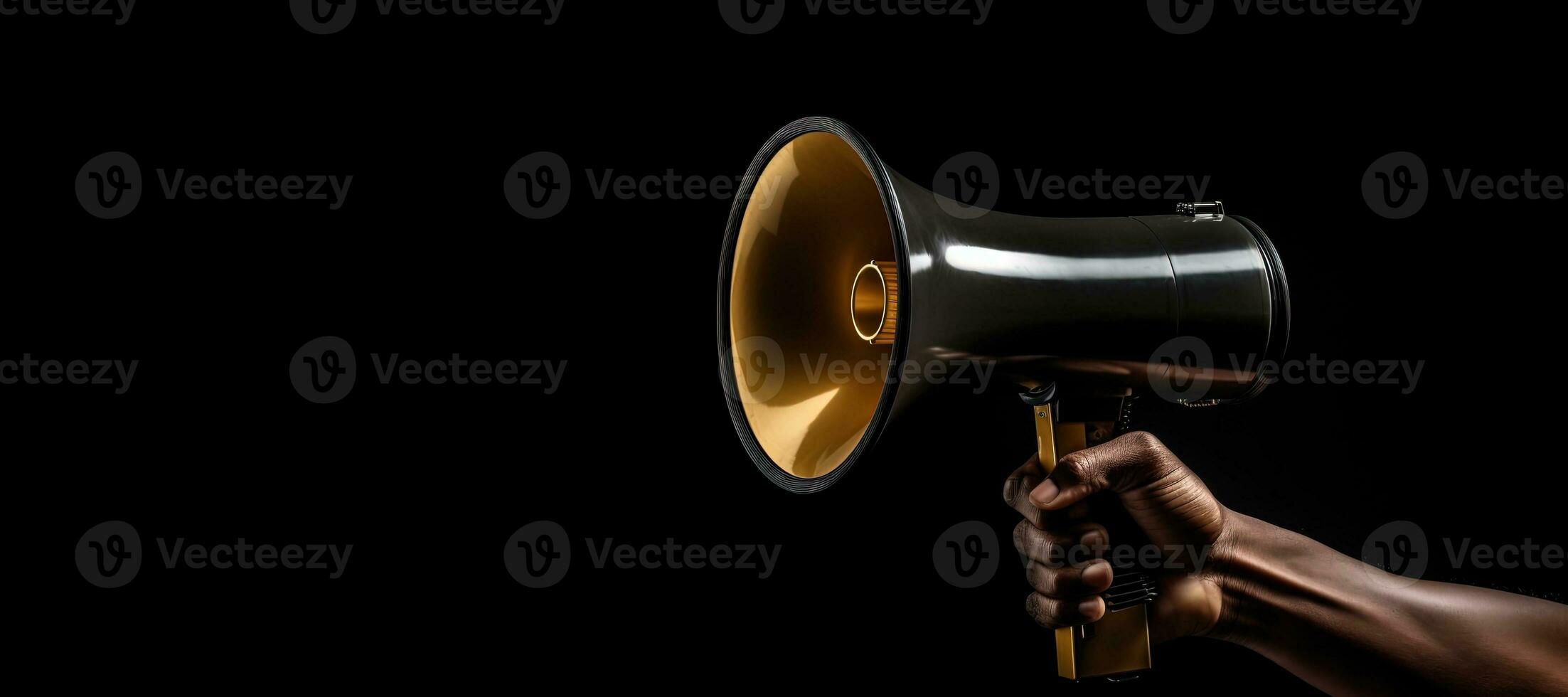 Generative AI, golden megaphone in hand on a empty black background, panoramic image with copy space photo