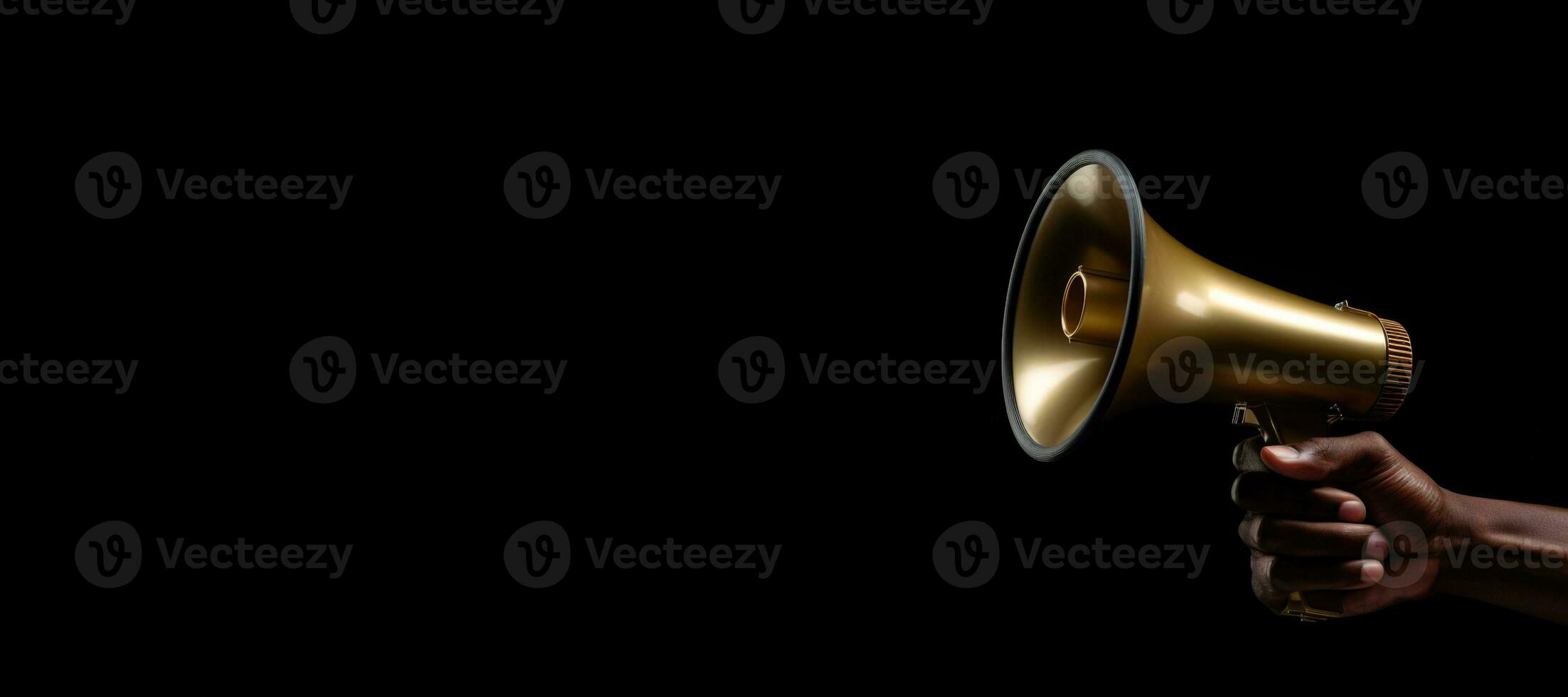 Generative AI, golden megaphone in hand on a empty black background, panoramic image with copy space photo
