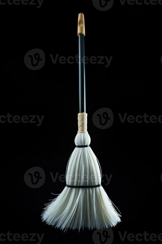 An elegant white broom interpretation isolated on a black gradient background photo