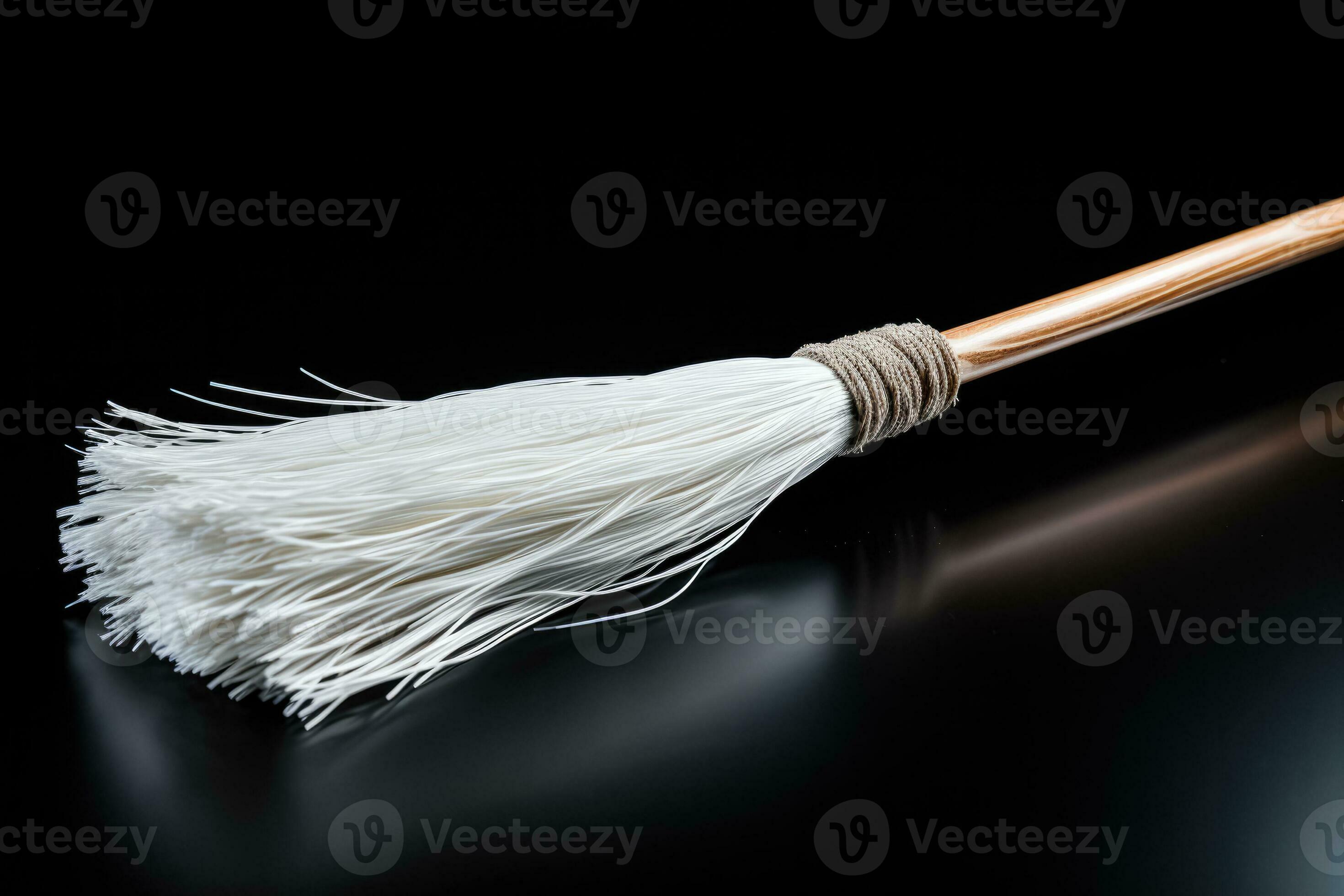 An elegant white broom interpretation isolated on a black gradient