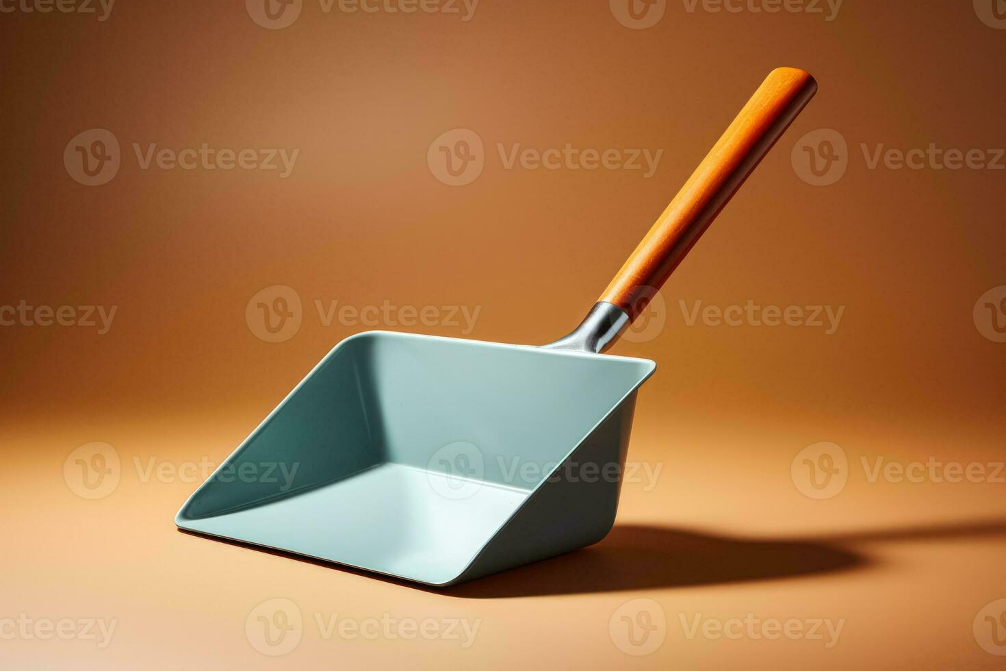 A simple metal dustpan isolated on a silver gradient background photo