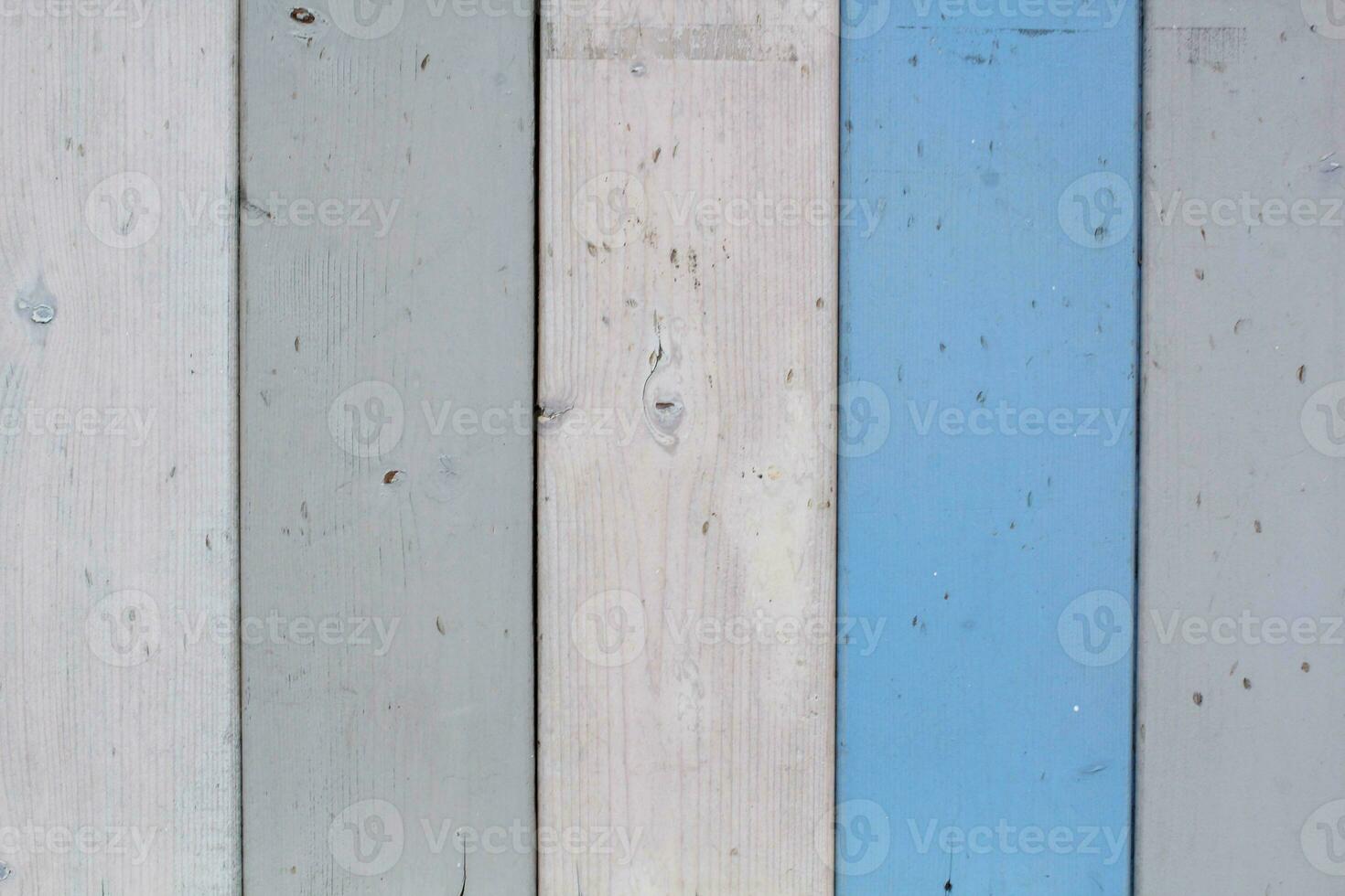 Texture of wood boards with cracked paint of white, beige, grey and blue color. Horizontal retro background with wooden planks of different colors. photo