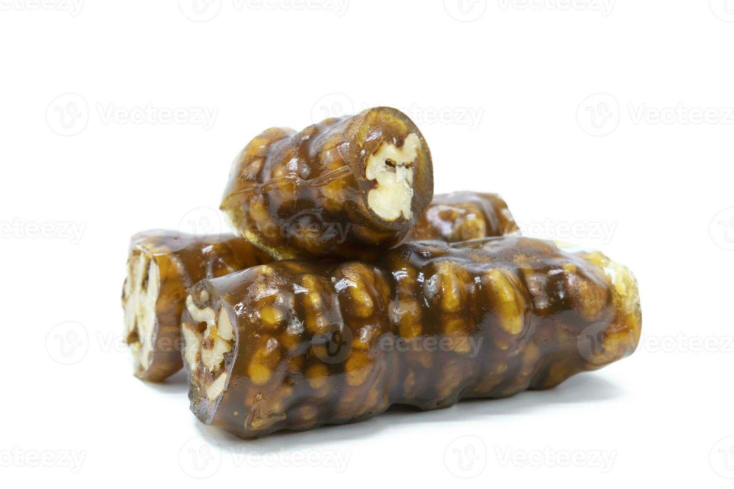 Traditional Turkish flavor made by dipping walnuts with a rope in a mixture of grape molasses. isolated on white background. photo