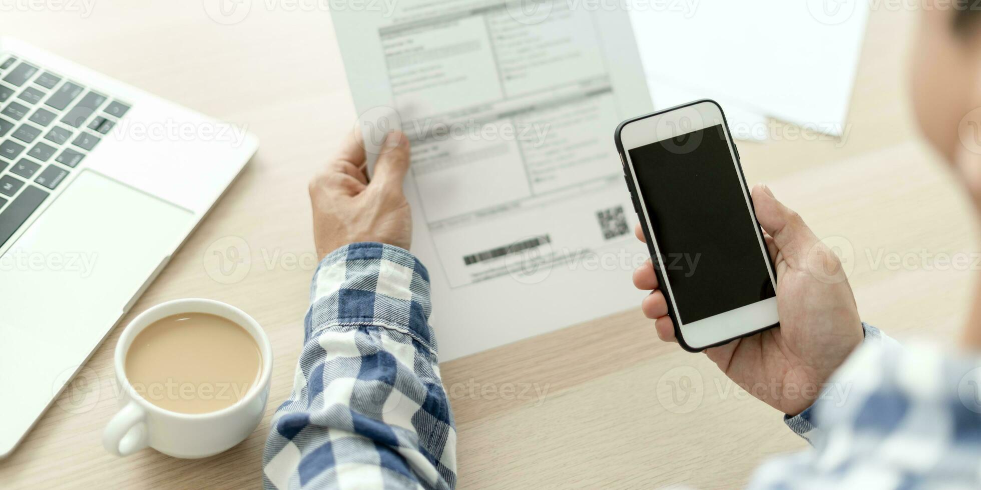 business man use phone to scan barcode or QR codes to pay credit card bill after receiving document invoice online. payment, receive, paying electricity, digital payments without money, technology photo