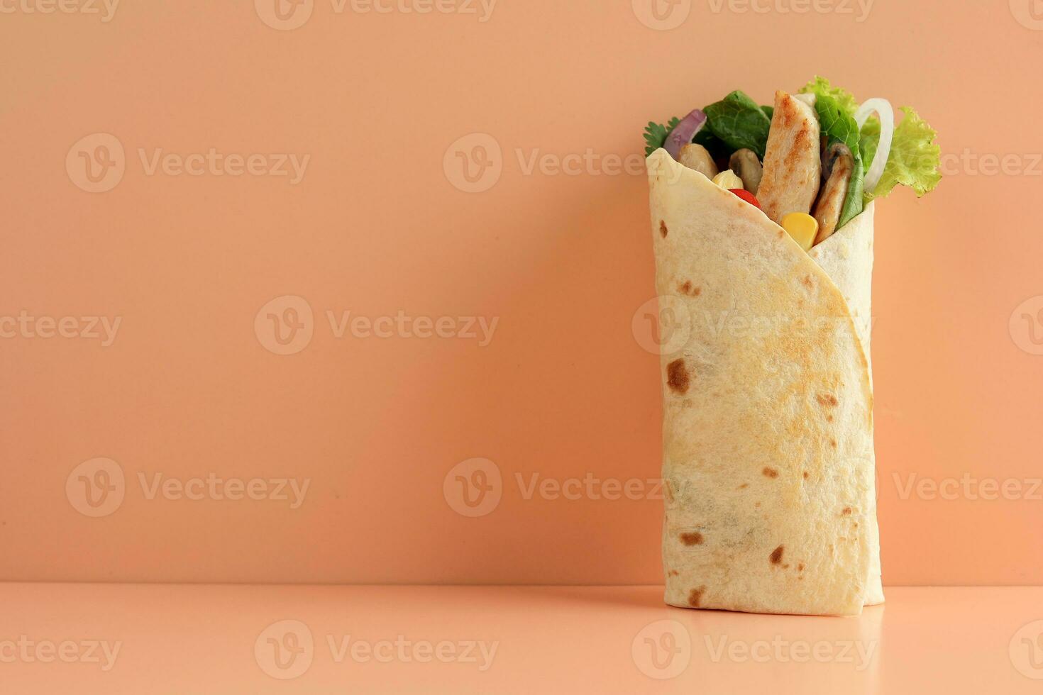 Delicious Chicken Wrap with Fresh Lettuce and Ripe Tomatoes in Tortilla photo