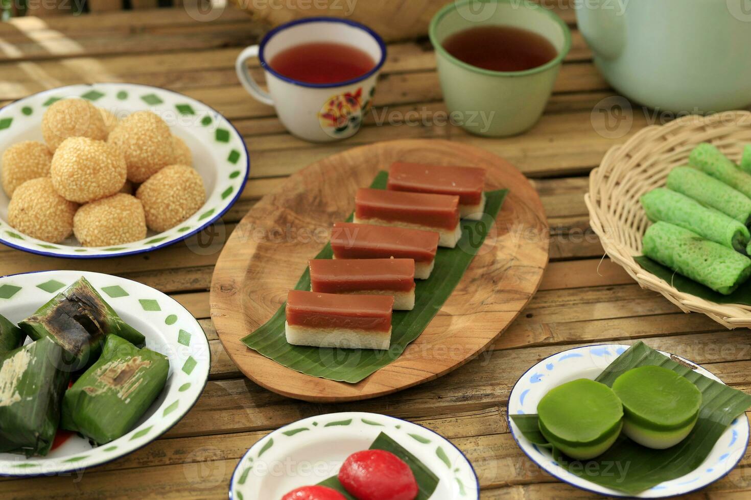 Various Kue Basah or Indonesia Jajan Pasar on Bamboo Table photo