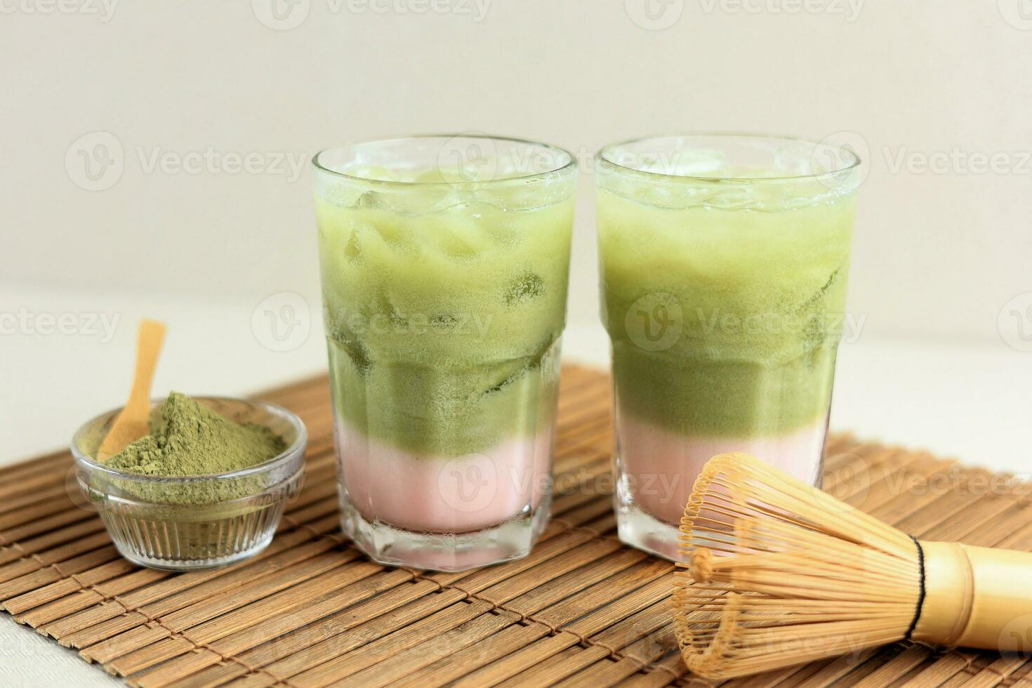 Cold Matcha Latte in a Tall Glass with Strawberry Milk photo