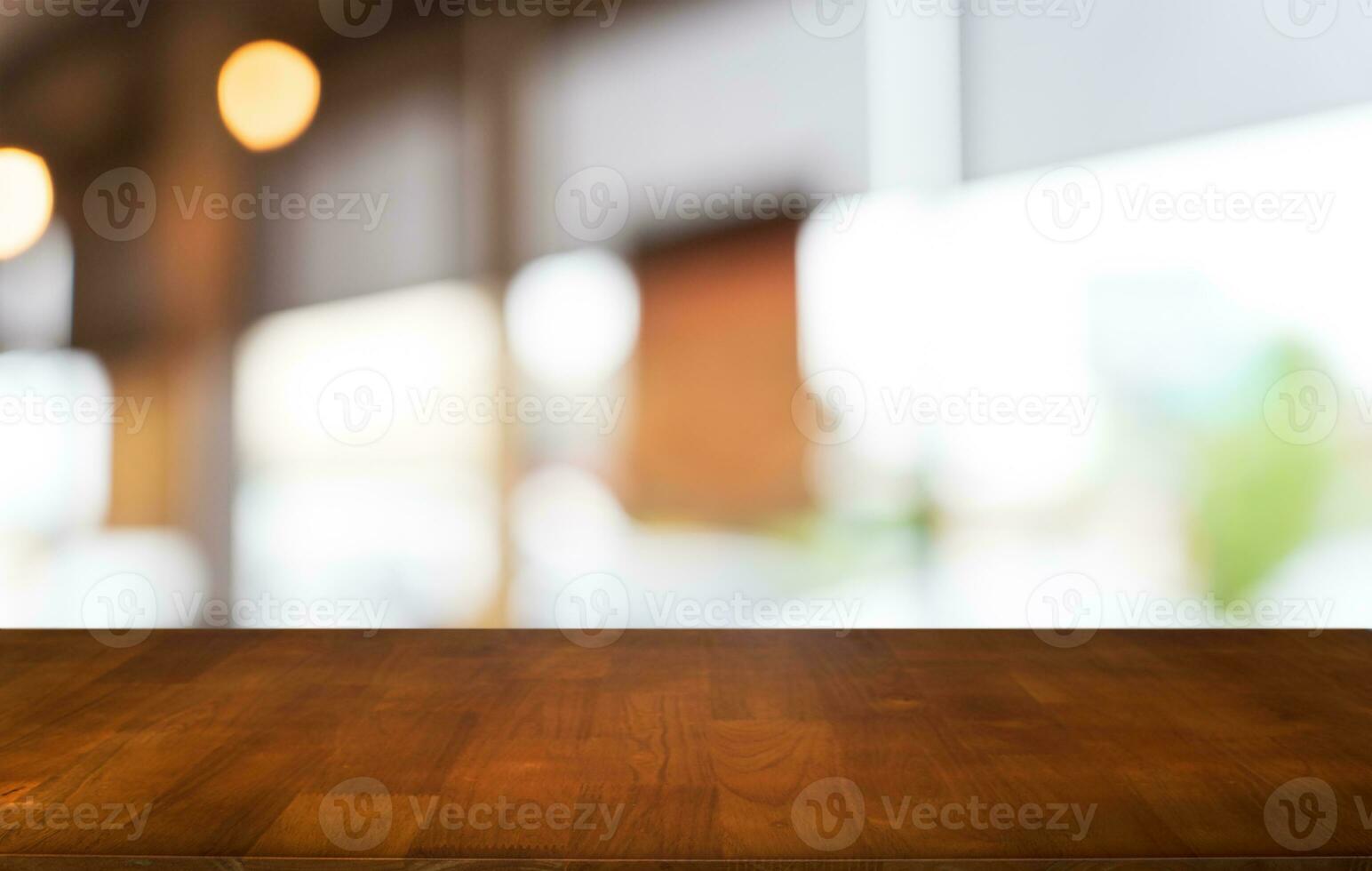 Mock up for space. Empty dark wooden table in front of abstract blurred bokeh background of restaurant . can be used for display or montage your product photo