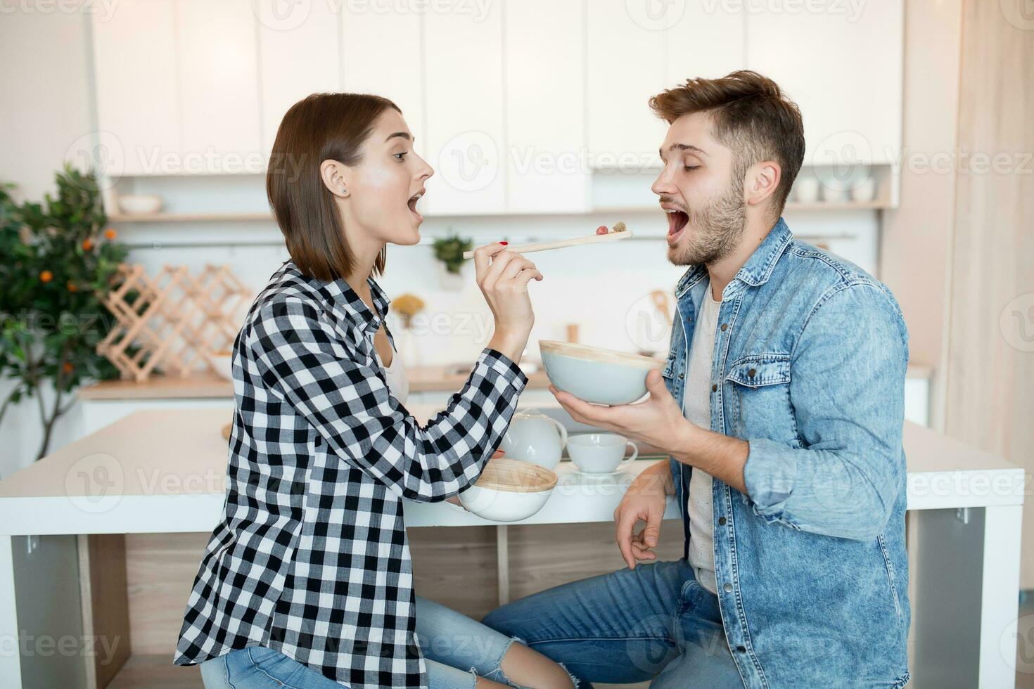 young happy man and woman in kitchen, breakfast, couple together in morning photo