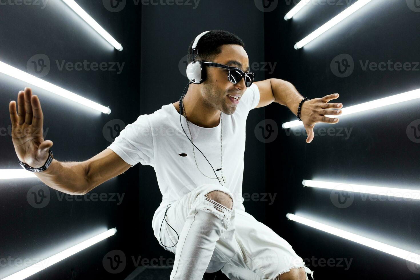 black man dancing in neon lights photo