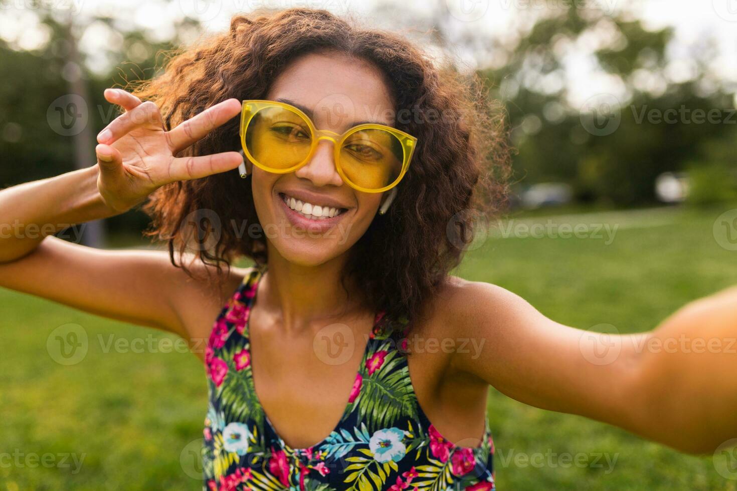 young stylish black woman having fun in park summer fashion style photo