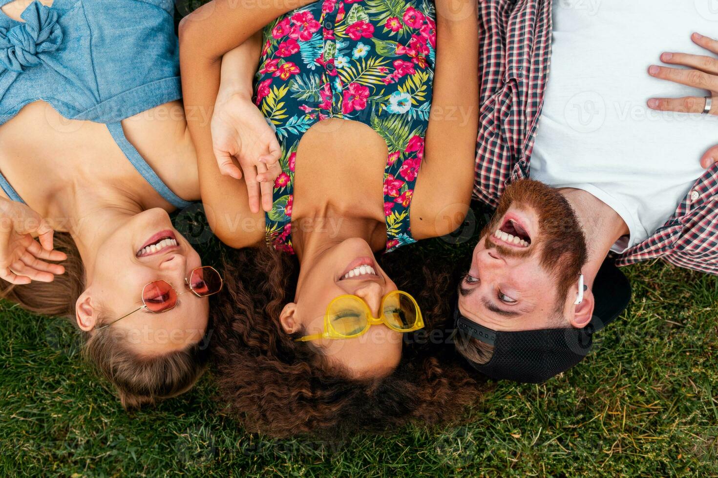 happy young company of friends sitting park photo