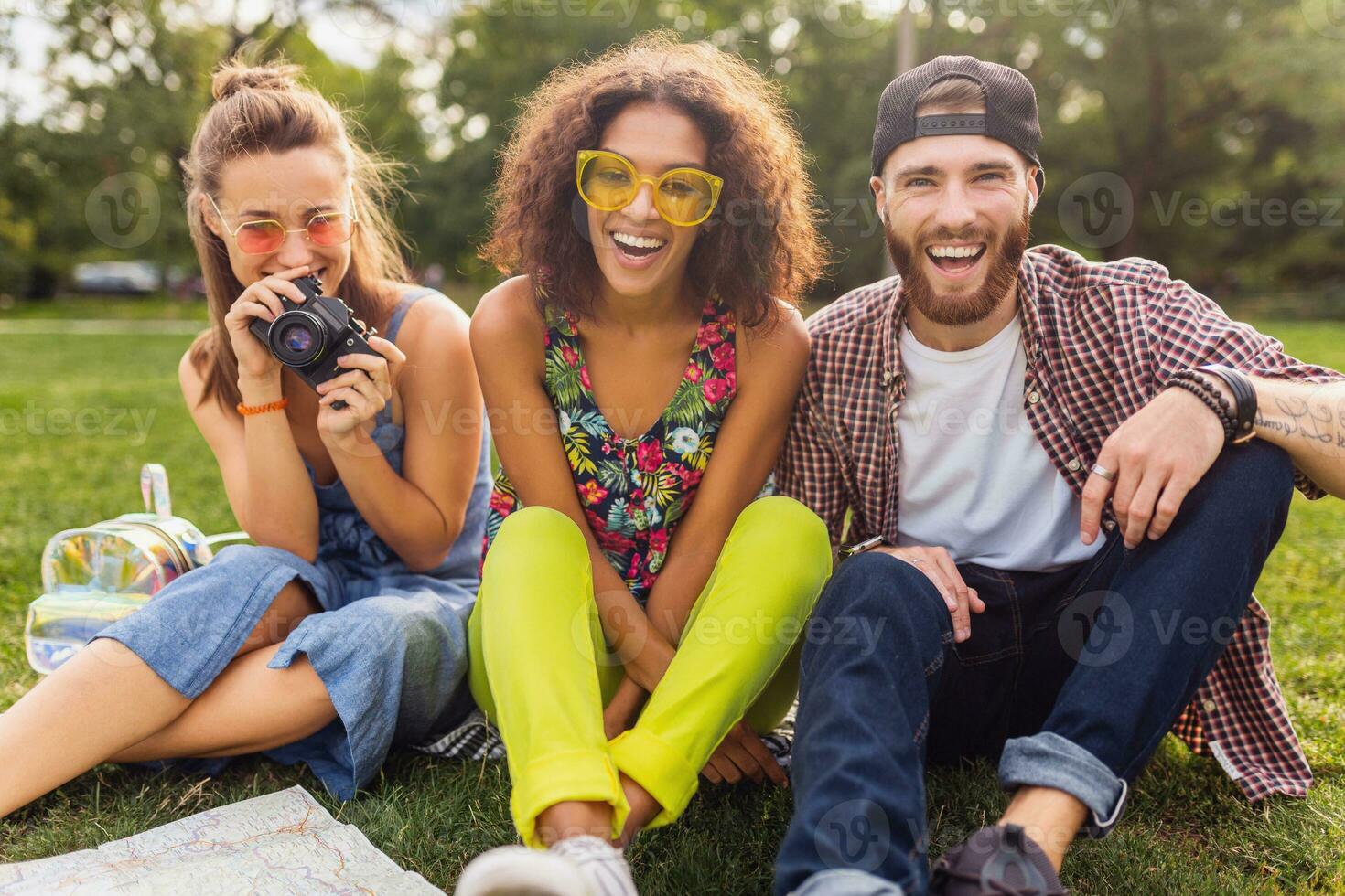 happy young company of friends sitting park photo