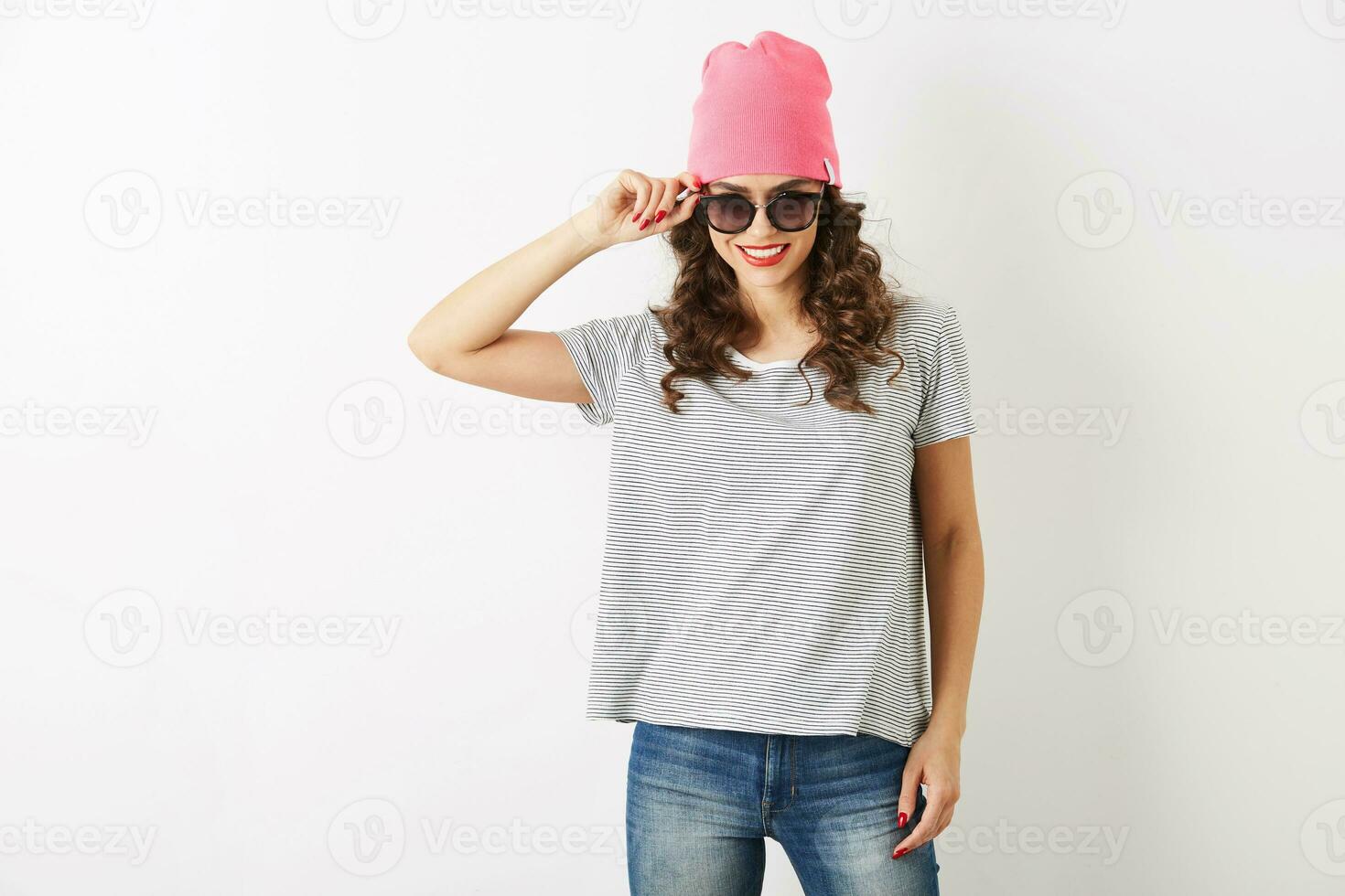 hipster pretty woman in pink hat, sunglasses, dancing happy, smiling face, long hair, positive mood, emotional, hipster style outfit, summer fashion trend, jeans and striped t-shirt, isolated photo