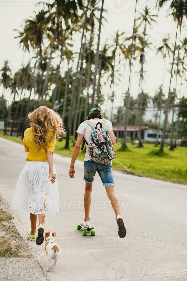 young stylish hipster couple in love on vacation with dog and skateboard photo