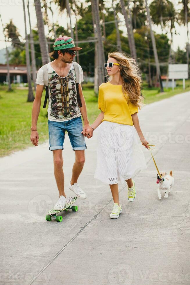 young stylish hipster couple in love on vacation with dog and skateboard photo