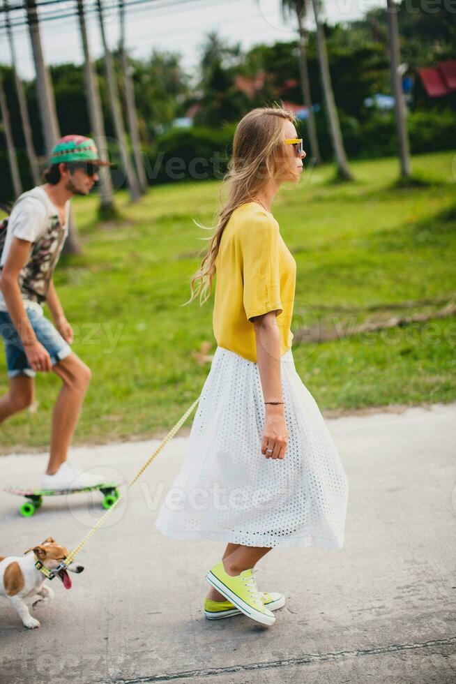 young stylish hipster couple in love on vacation with dog and skateboard photo