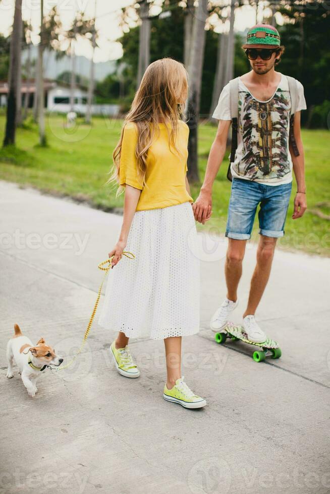 young stylish hipster couple in love on vacation with dog and skateboard photo