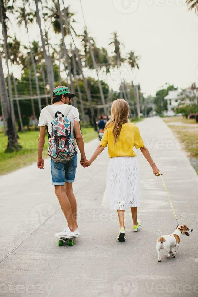 young stylish hipster couple in love on vacation with dog and skateboard photo