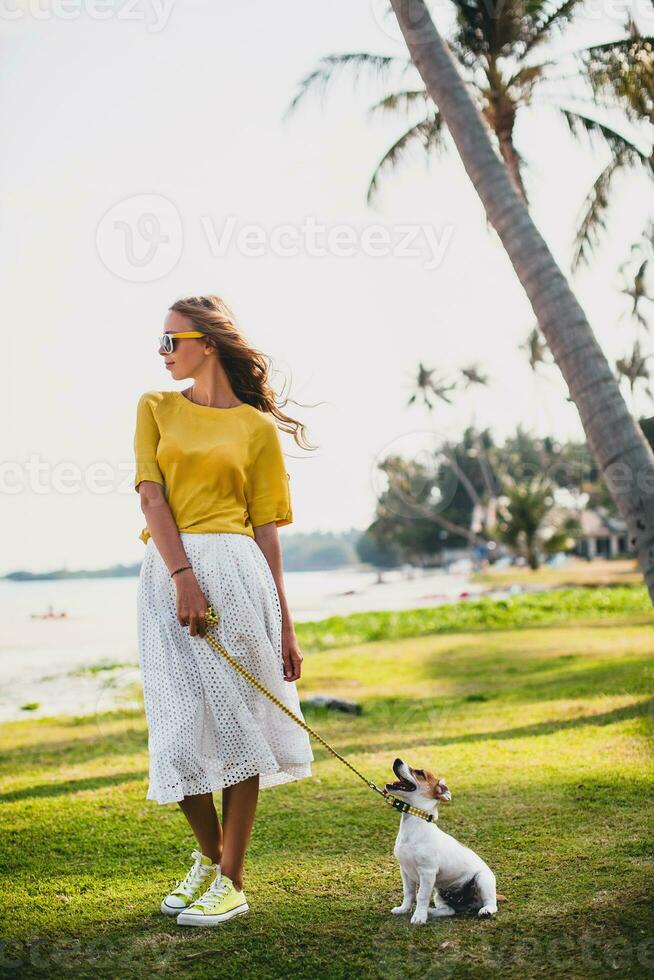 young stylish hipster woman holding walking playing dog puppy jack russell photo