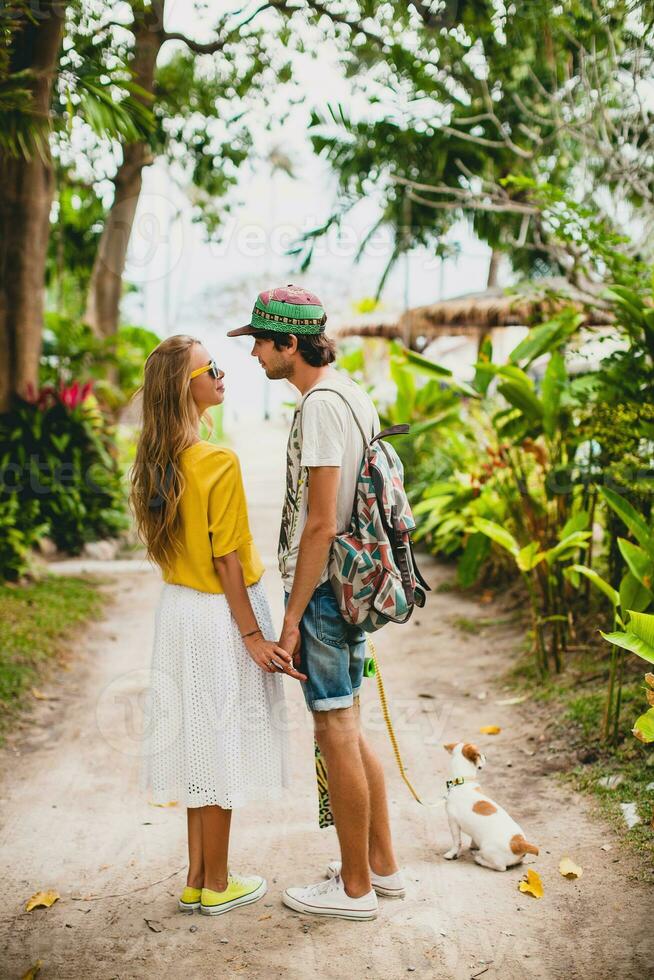 young stylish hipster couple in love on vacation with dog photo