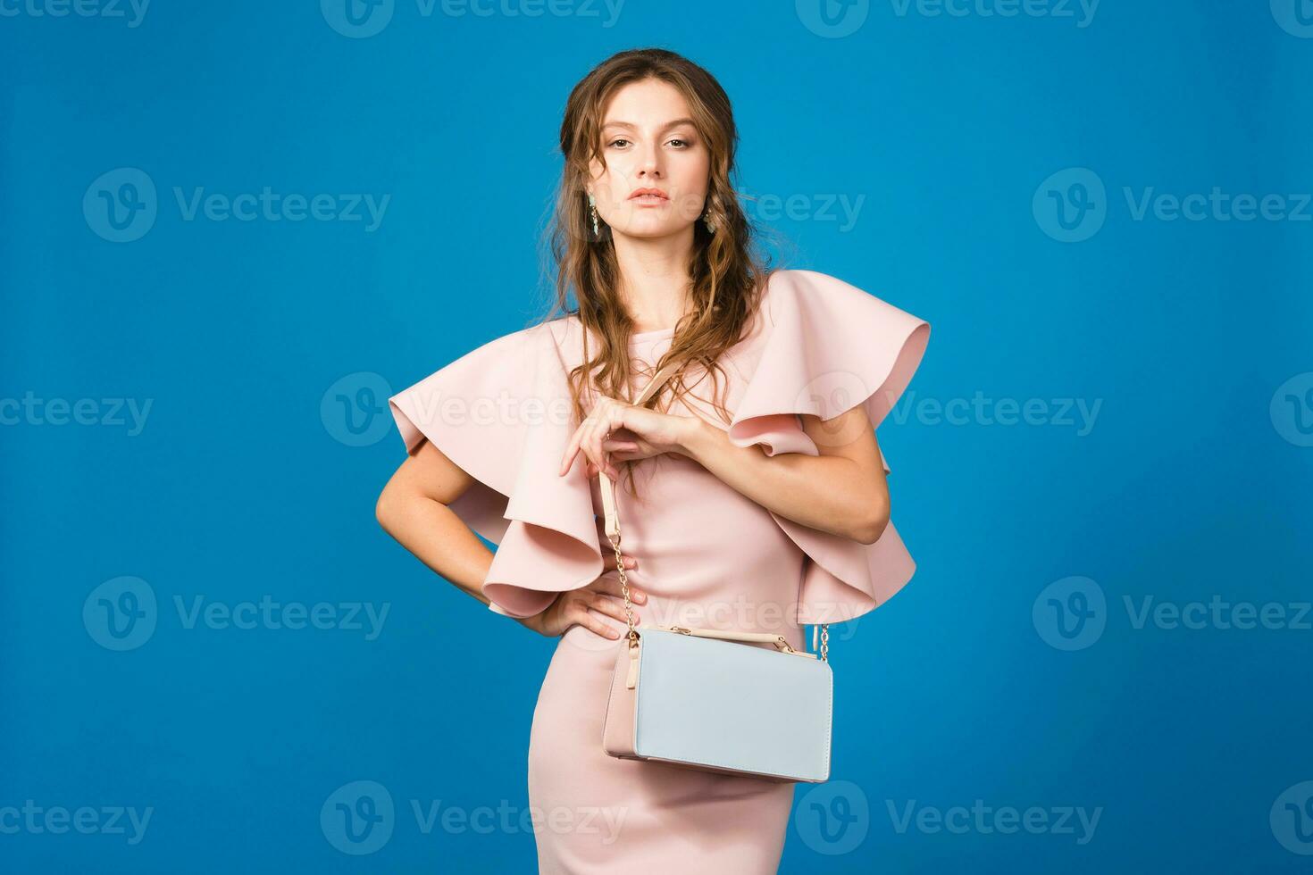 young stylish sexy woman in pink luxury dress, summer fashion trend holding trendy handbag photo