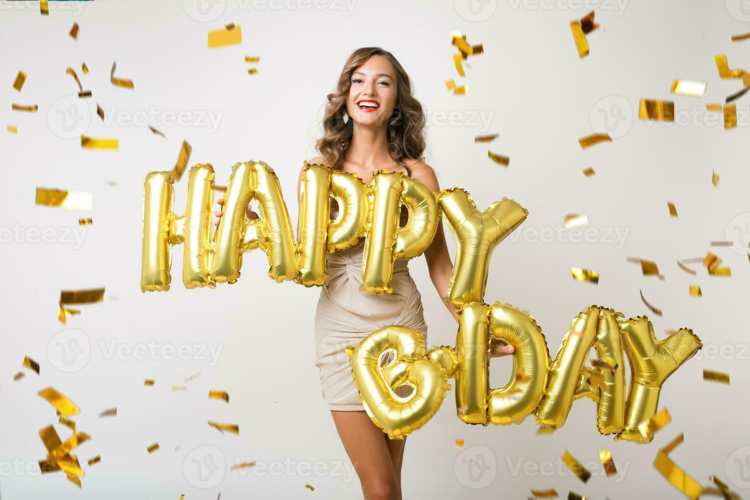 pretty woman celebrating party in golden confetti photo