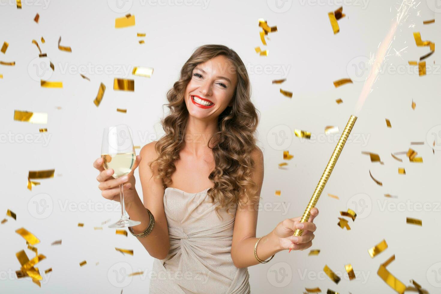 pretty woman celebrating party in golden confetti photo